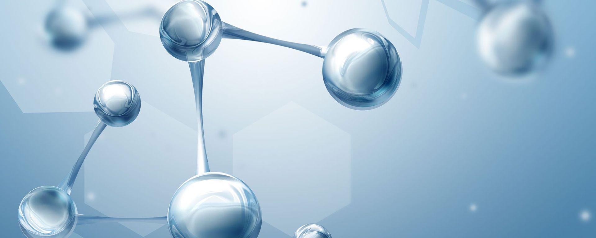 Glossy translucent molecular spheres linked together against a soft blue background